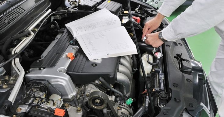 Logbook Mechanic performing professional car AC servicing and inspection